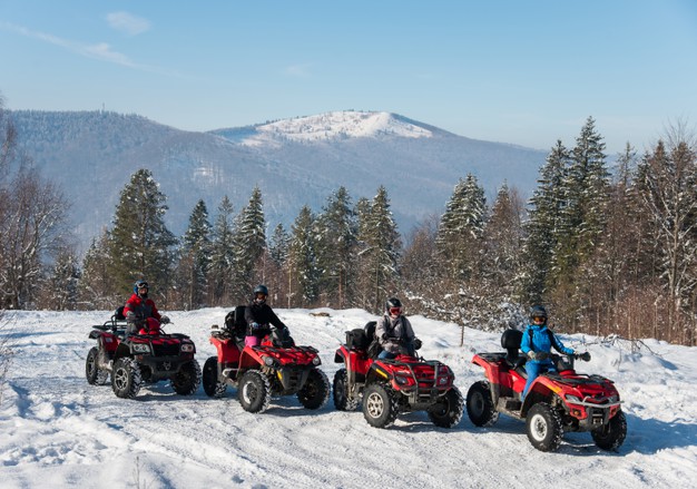 four-atv-riders-off-road-quad-bikes-top-mountain-winter_10069-4855